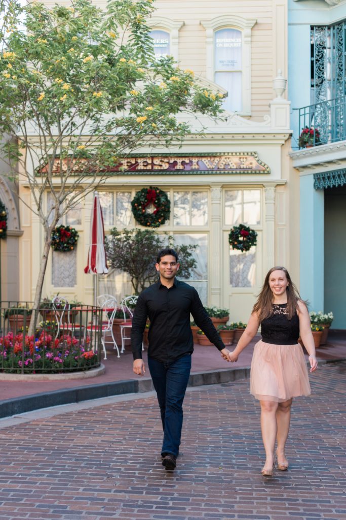 Couple walking hand in hand in Disney