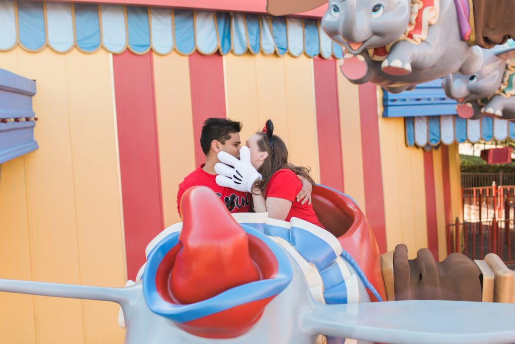 Couple kissing on ride in Magic Kingdom for Engagement Shoot