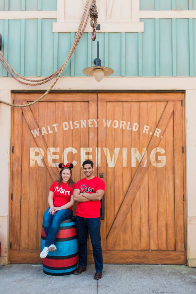 Couple posing my Disney Receiving sign in Magic Kingdom