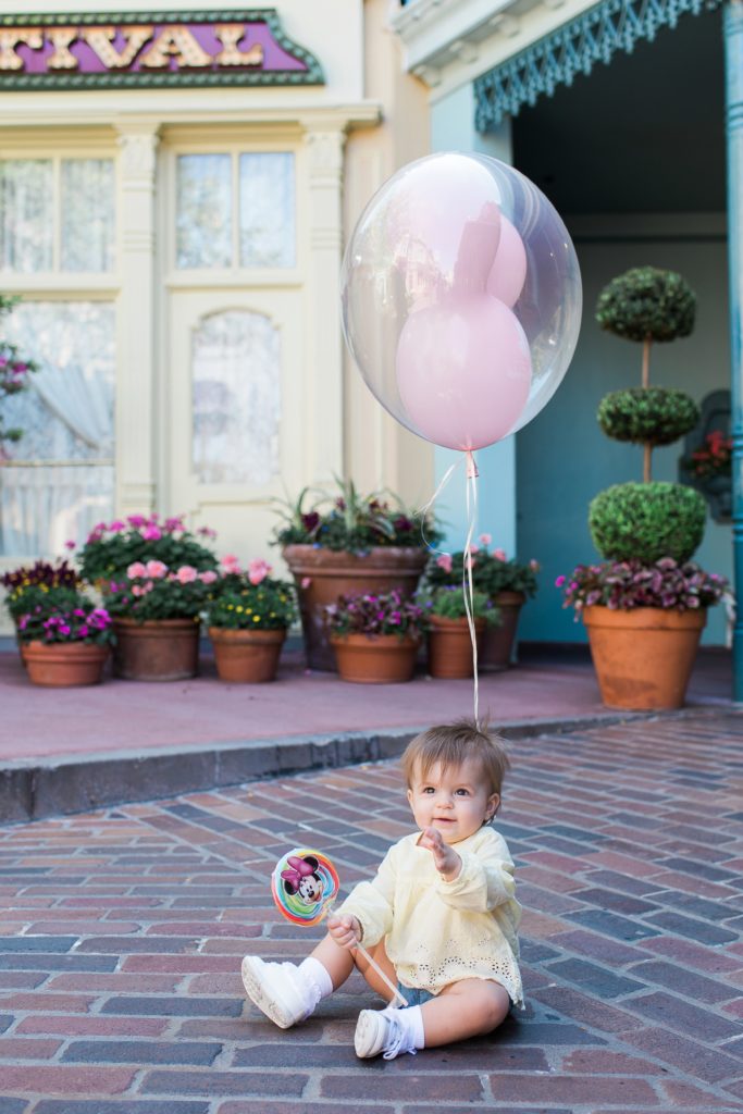 Baby holding balloon