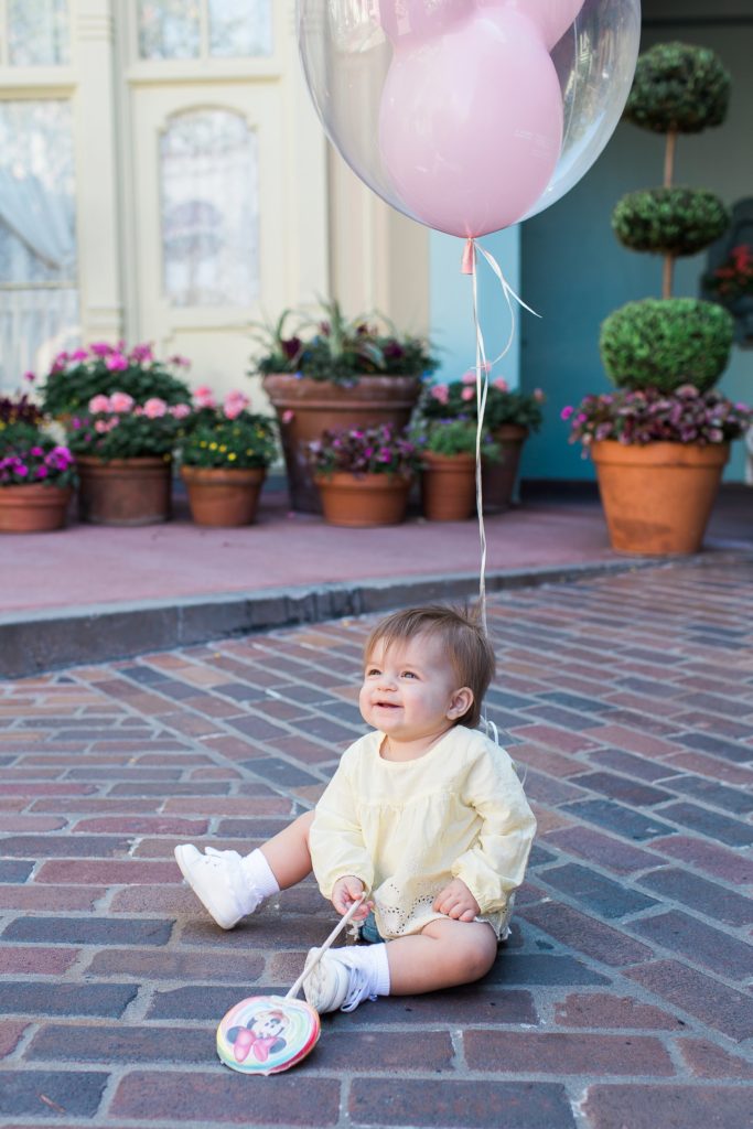 baby holding balloon