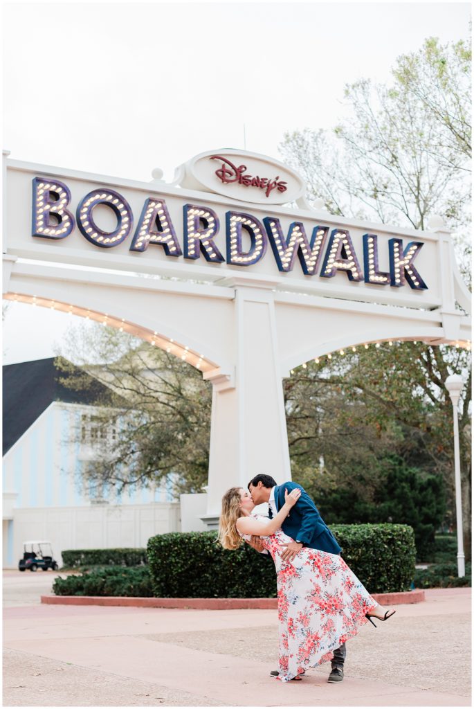 boardwalk marquee sign and couple dip kissing underneath