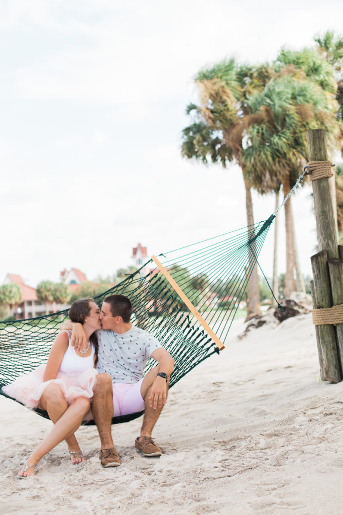 Disney's Caribbean Beach engagement session at Walt Disney World Orlando, Florida with Jess Collins photography on the beach with couple sitting in the hammock.