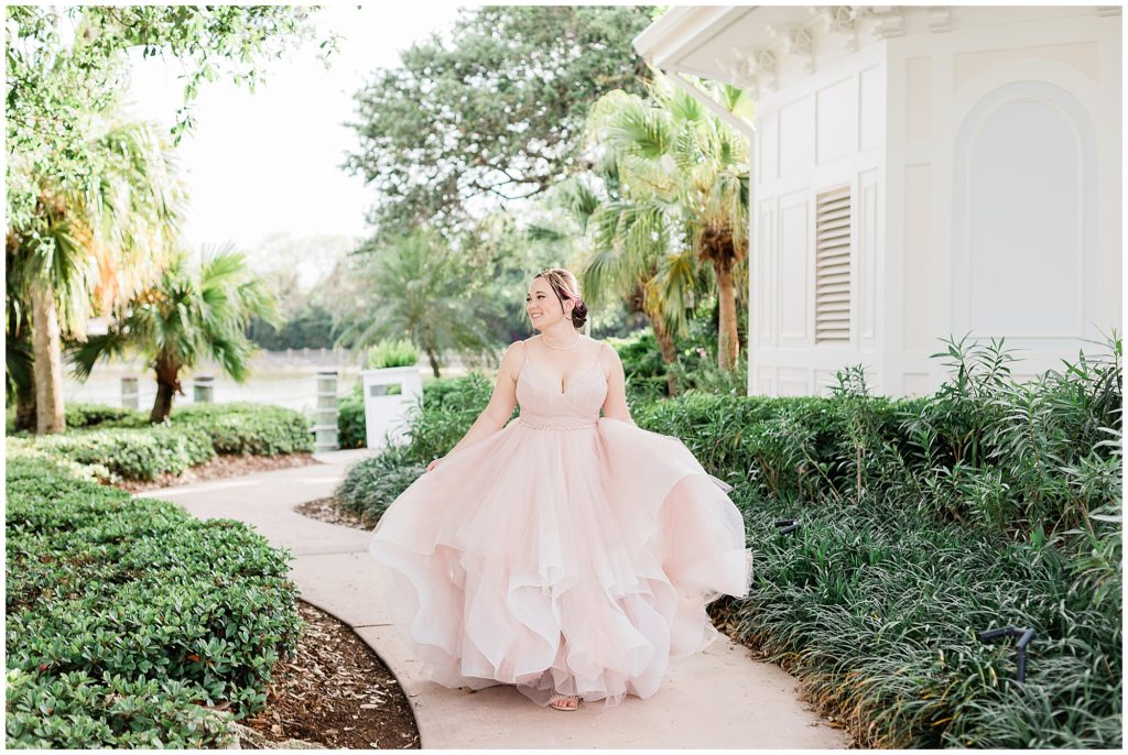 walking and twirling in wedding gown at Grand Floridian Resort