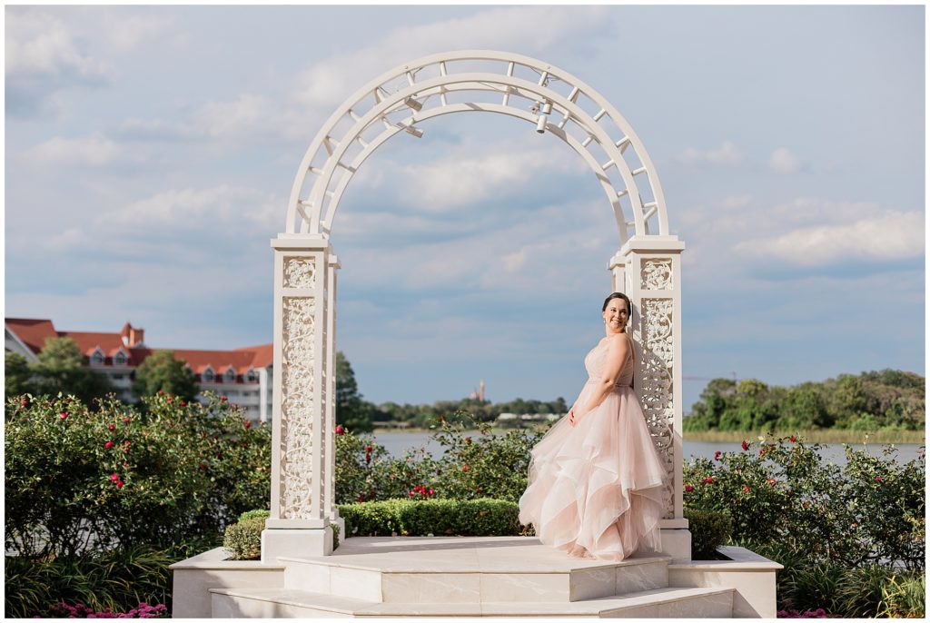 Bride leaning on arch at Disney's picture point