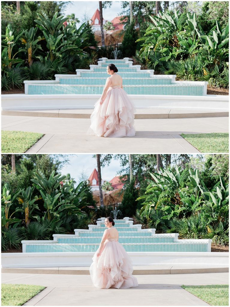 bride showing back of dress infront of big blue fountain