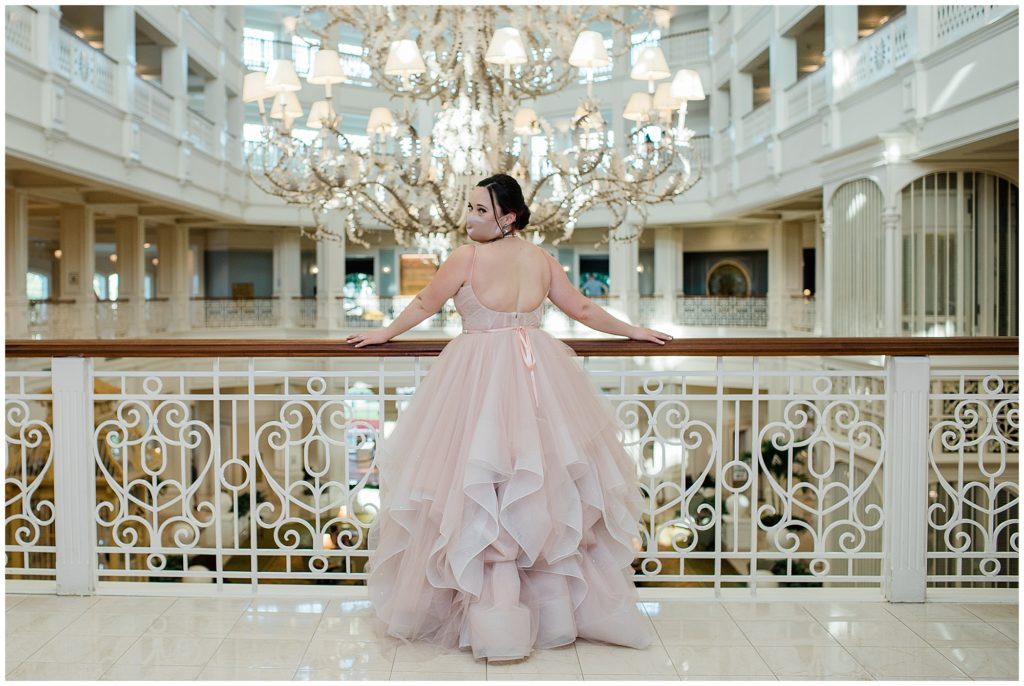 Bride overlooking balcony at Grand Floridian Resort & Spa in wedding gown