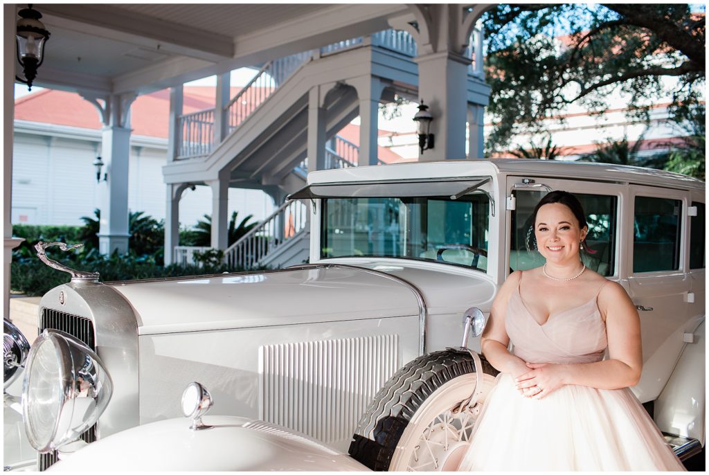 Bride in front of vintage car at Disney's Grand Floridian resort