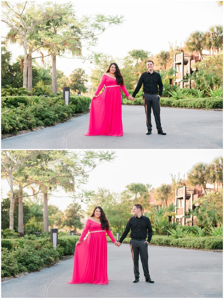 Couple holding hands during their engagement session with her holding her dress