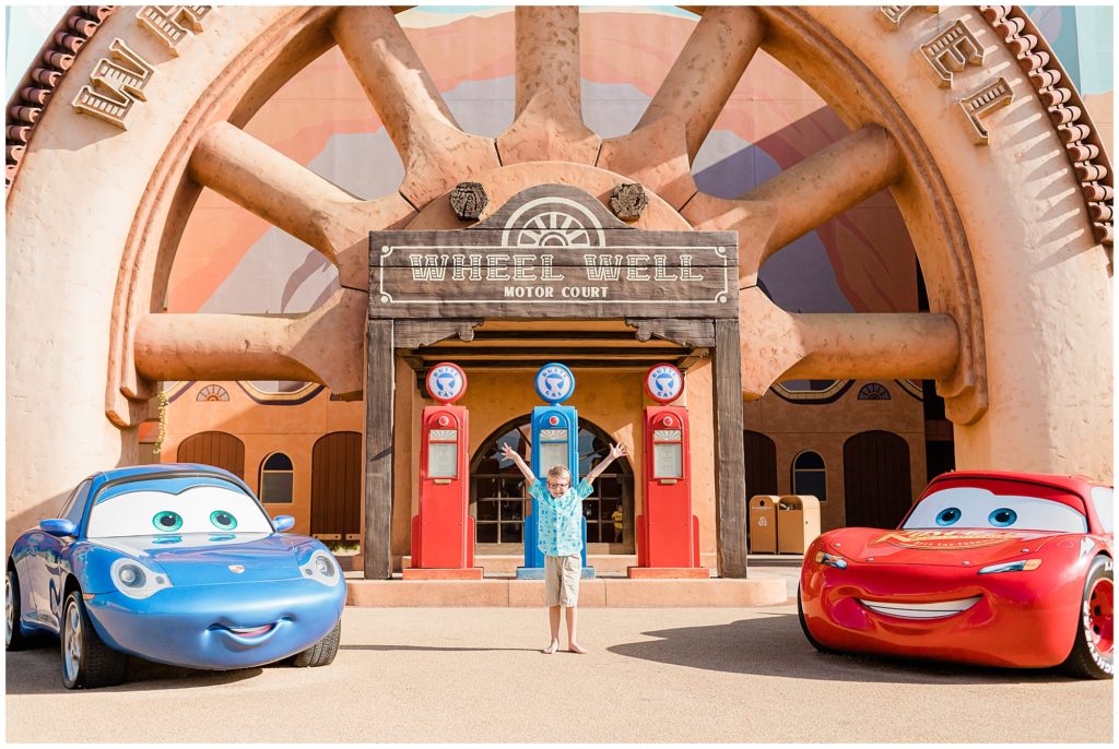 Radiator Springs cars section at Art of Animation kid smiling under sign