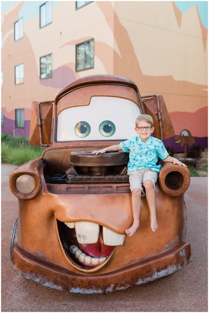 Disney's Art of Animation resort Tow Mater with boy sitting on hood