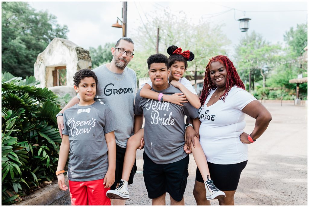 group of family members standing together smiling at the camera at Disney World