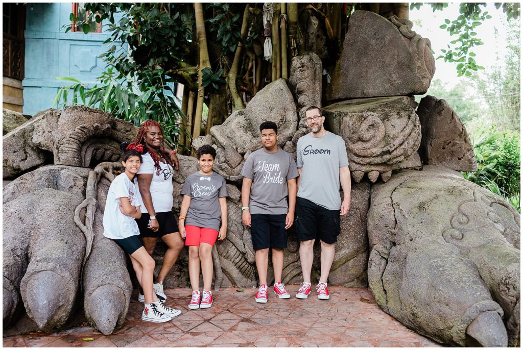 Family at Disney's Animal Kingdom standing by rock statue in Asia