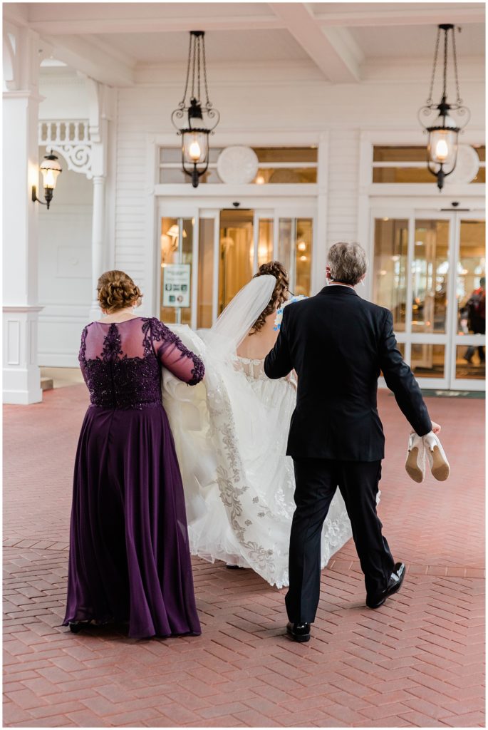 bride with parents walking into the Grand Floridian