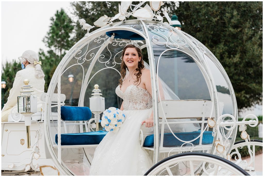 smiling bride in doorway in coach in wedding gown