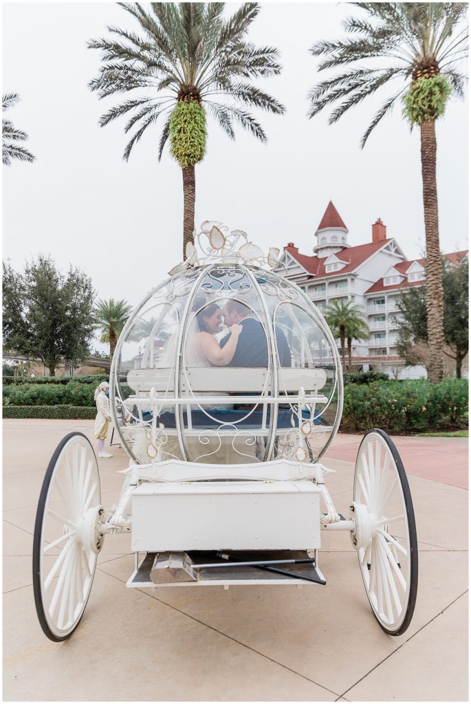 couple kissing in wedding coach at Disney's Wedding Pavilion