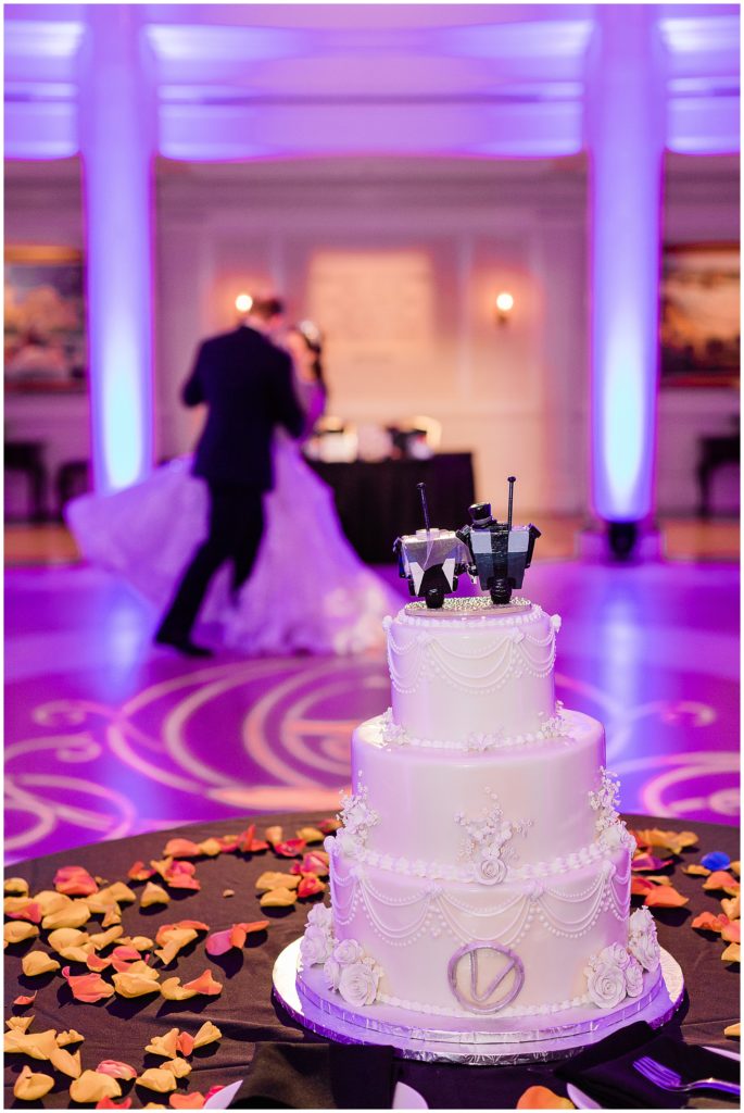 cake with couple dancing in the background