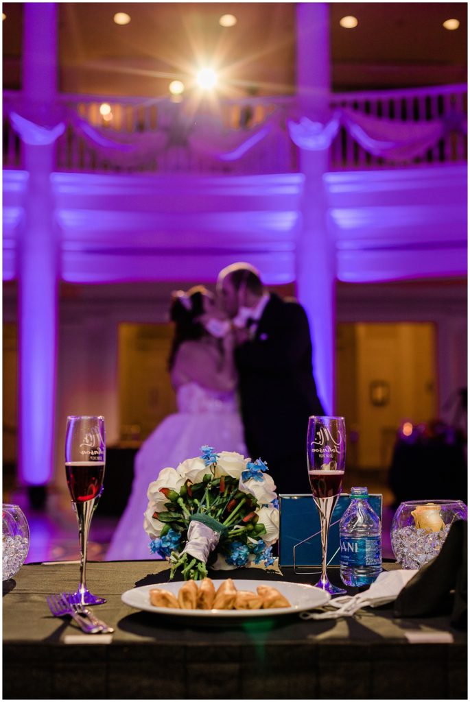 bride and groom kissing in spotlight and end of wedding reception